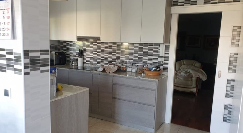 View of a modern villa facade featuring a pool, garden and large windows that illuminate the interior. Minimalist design.
