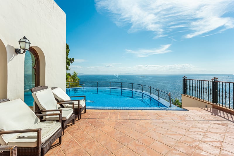 Panoramic view of a luxurious villa with pool, garden, and modern architecture. Features large windows and minimalist design.