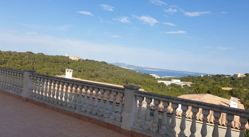 Exterior view of a modern villa with infinity pool, lush garden, and minimalist architecture. Warm lighting and elegant design.