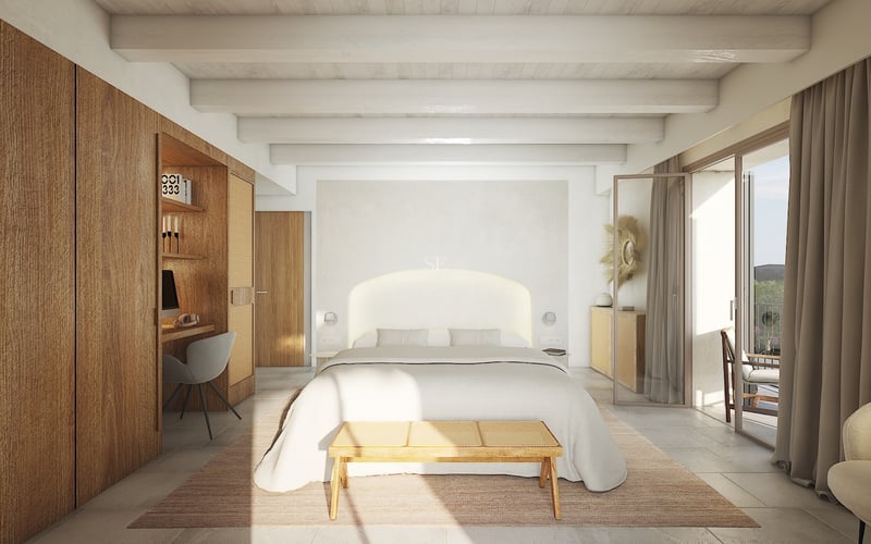 Chambre lumineuse avec poutres blanches, armoires en bois intégrées avec bureau, grand lit et accès au balcon.