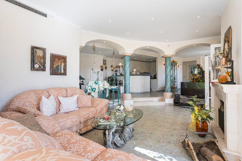 Aerial view of modern villa with infinity pool. Minimalist design, large outdoor spaces, lush gardens, and panoramic views.