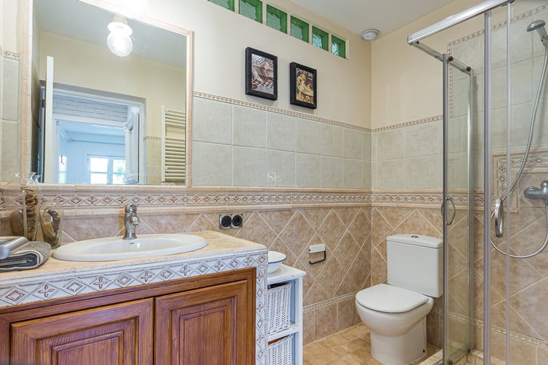 Exterior view of a modern villa featuring a pool, garden, and minimalist architectural design. Large windows and high-quality materials.