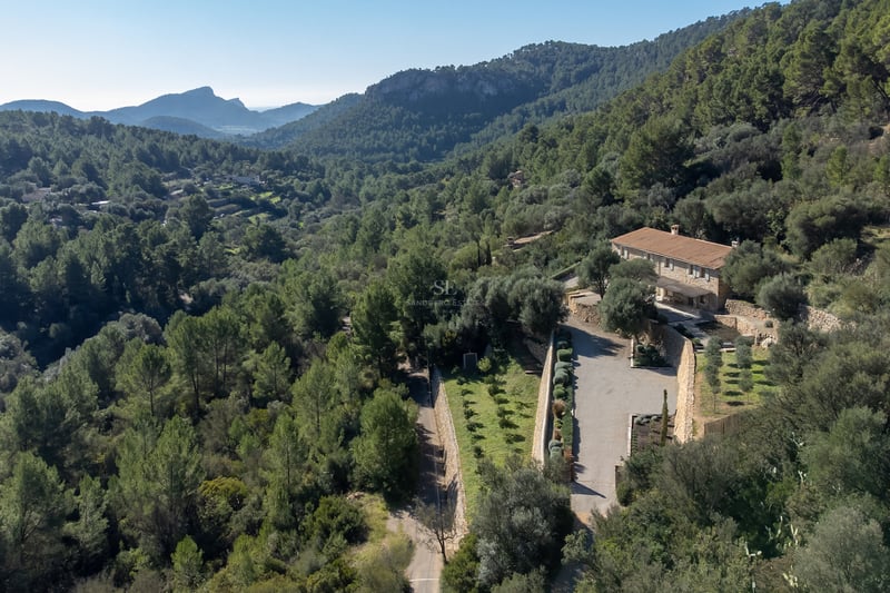 Exterior view of a luxury villa with a pool, manicured garden, and modern architecture. Minimalist design and large window panes.